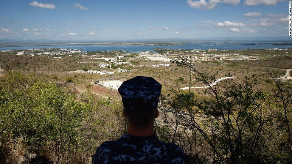 A navy sailor surveys the u. S. Naval base at guantanamo bay in october 2009. In december 2013, congress passed a defense spending bill that makes it easier to transfer detainees out of the facility.