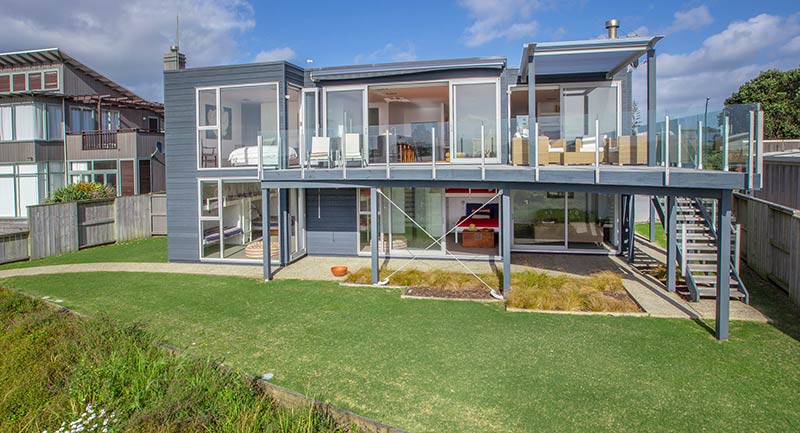 A home on omaha beach, north of auckland, illustrates the kind of modern design and top-end construction now common among vacation homes, popularly called baches