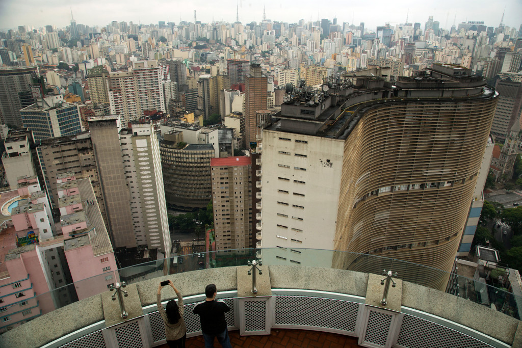 Visitors take pictures from the terrace of the Italia building in downtown Sao Paulo, Brazil, Tuesday, Nov. 26, 2013