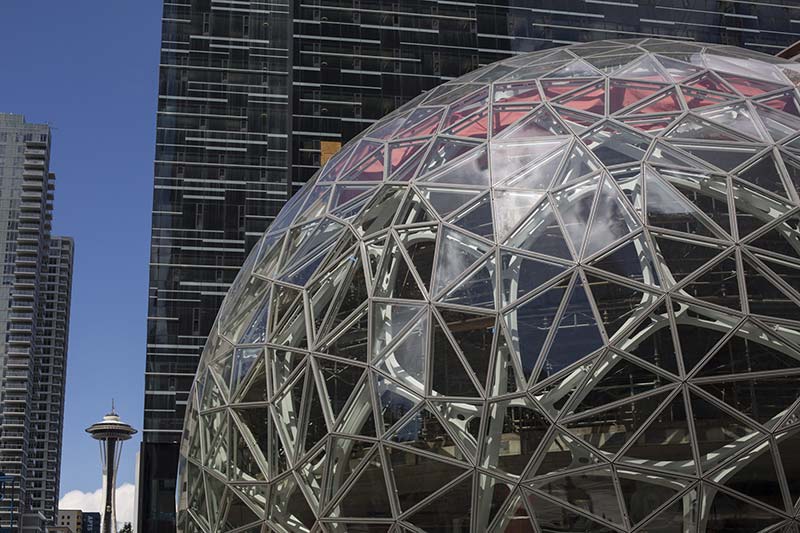 The Space Needle in Seattle, left, near Amazon's new office tower and spheres