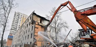 An excavator demolishes a five-storey apartment block in Moscow in April