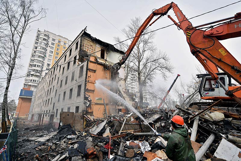 An excavator demolishes a five-storey apartment block in moscow in april