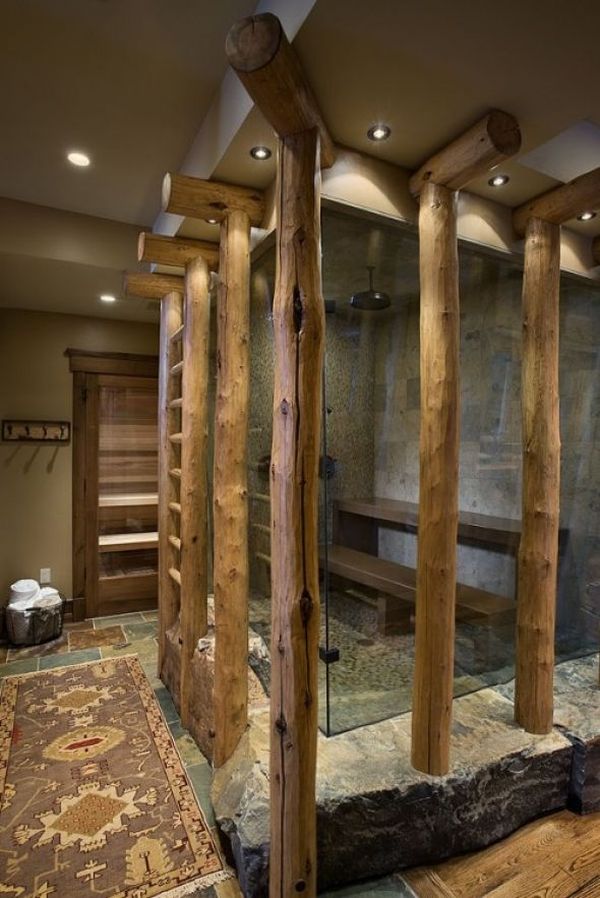 The rustic shower enclosure adorned by wooden logs