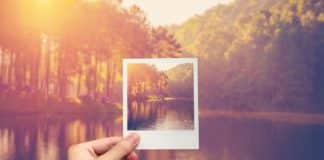 hand hold instant photo Pond water and sunrise with vintage effect.
