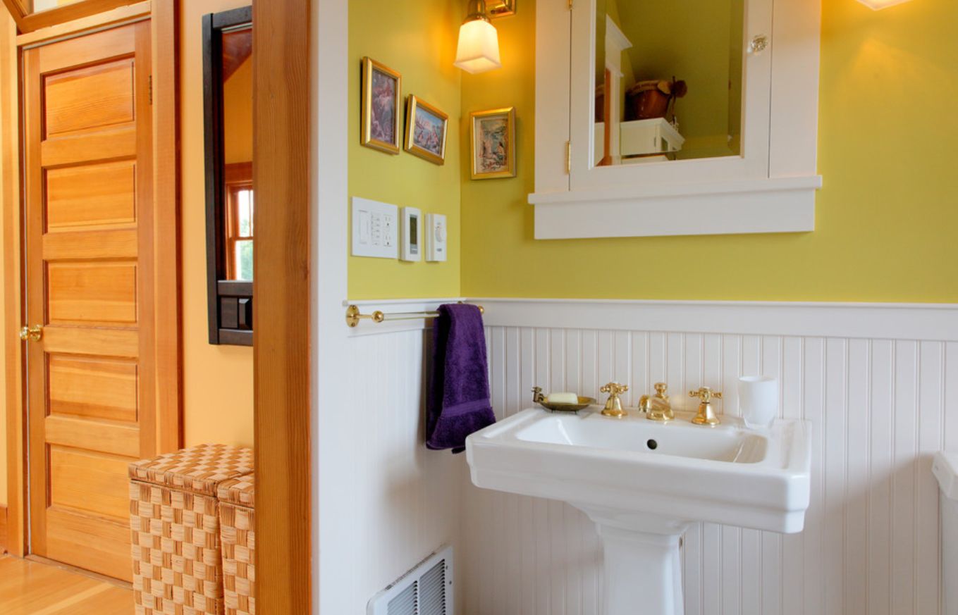 Yellow wall bathroom with white beadboard