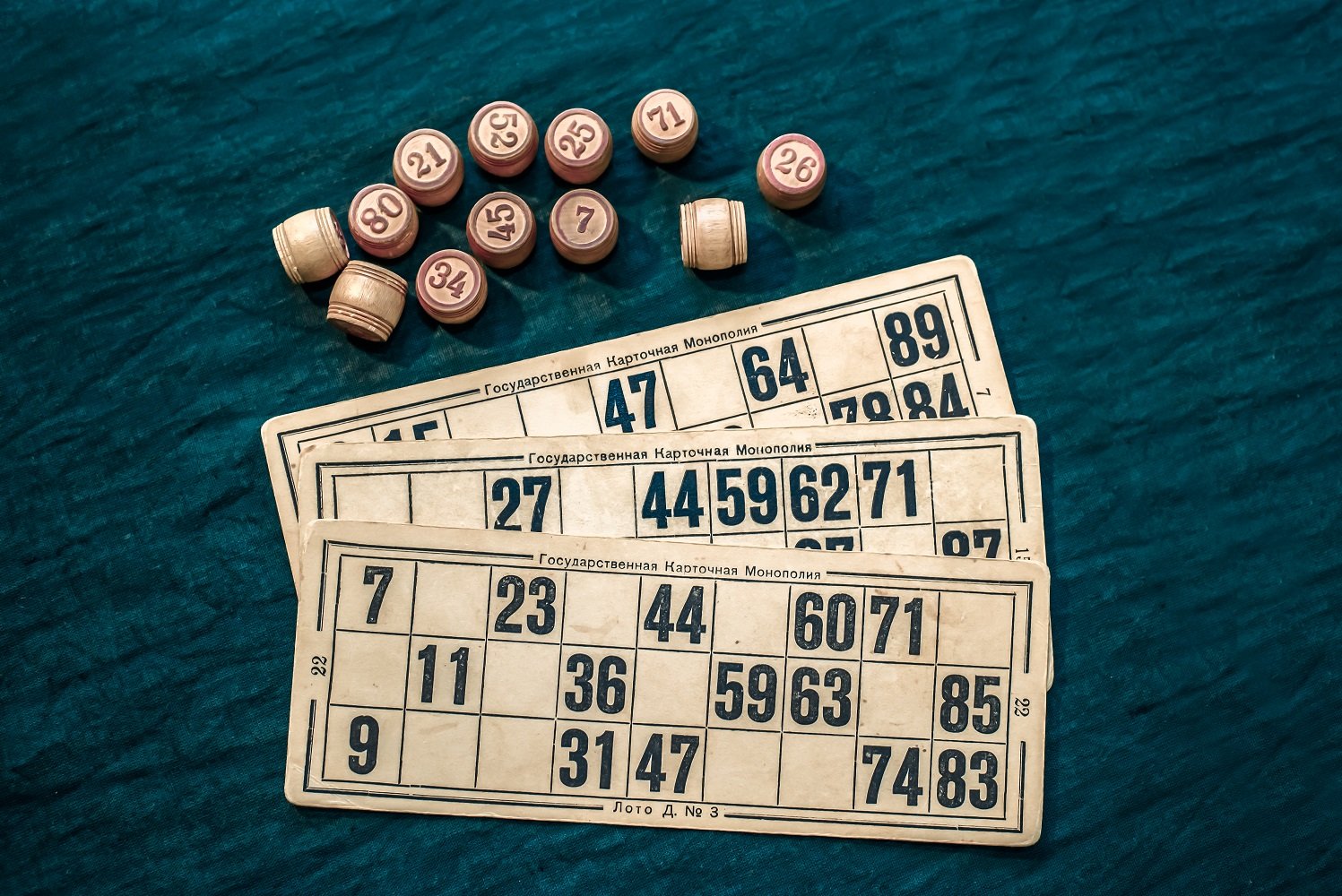 The game of bingo consists of cards and barrels with numbers on a green background, the game russian lotto