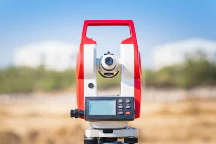 Surveyor equipment tacheometer or theodolite outdoors at construction site for civil engineer checking the construction area