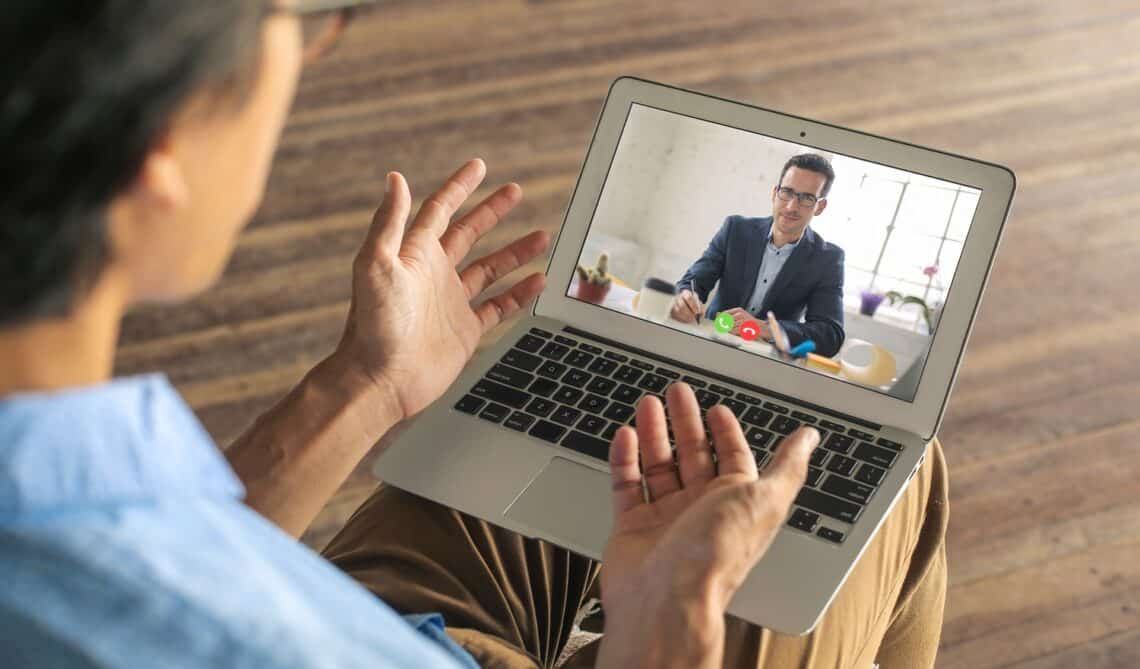 Man applying for a remote work. He is doing his interview on a video call.