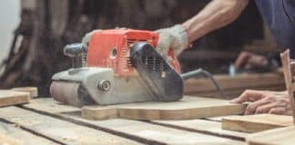 Carpenter sanding wood with the Best Belt Sanders 