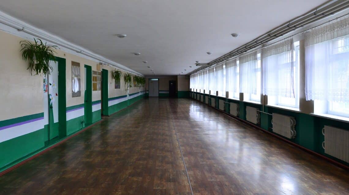 The gloomy corridor of a neglected public building. Public space in a poor residential high-rise building