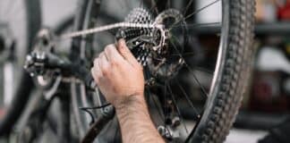 Bicycle mechanic in a workshop in the repair process .