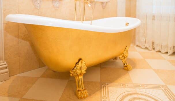 Old fashioned luxirious golden bath tub in a bathroom
