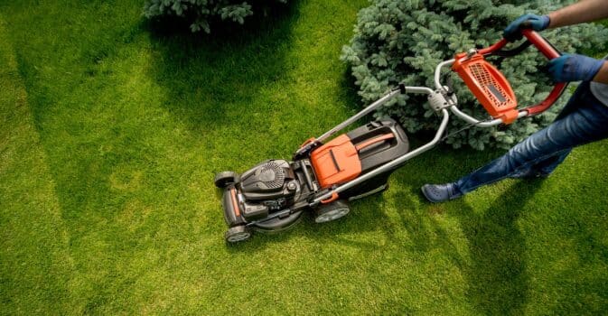 Gardener mowing the lawn. Landscape design. Gardening