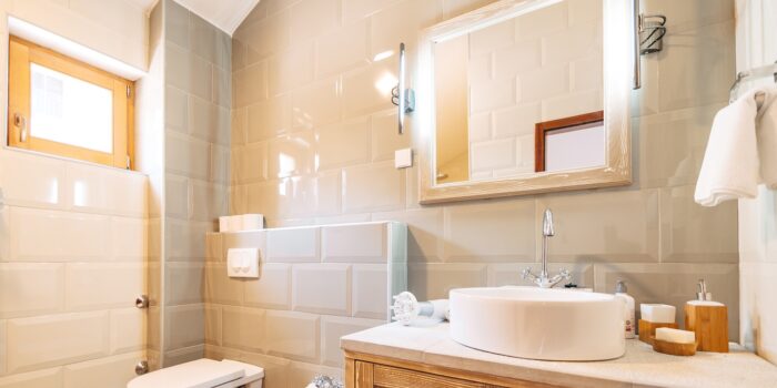 White washbasin with large mirror, towel holder and led lamp in the bathroom next to the toilet and bidet. High quality photo