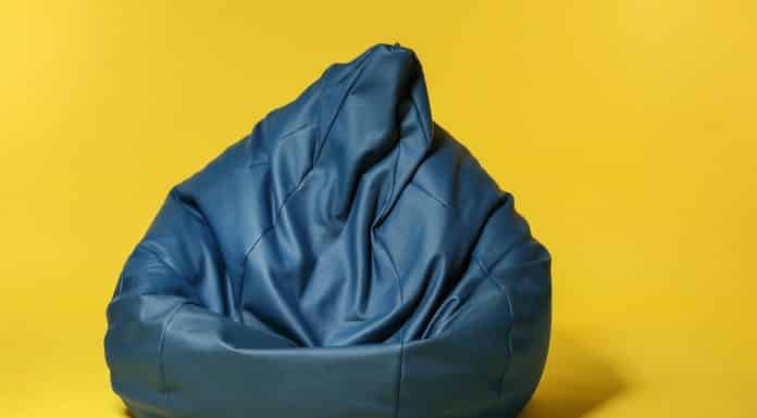 Beanbag chair on color background