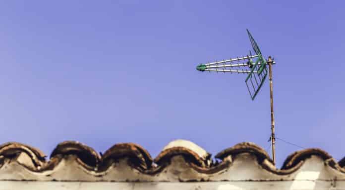 Television antenna on the old roof with blue sky background in Andalucia, Spain