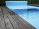 Automatic swimming pool covering system, safely protect children and pets from accidental contact with water, home and cottage equipment, copyspace, place for text, outdoor exterior