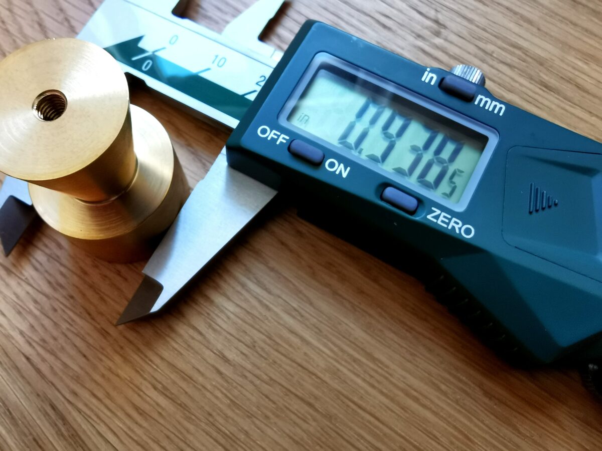Digital caliper measuring diameter of a rbass knob
