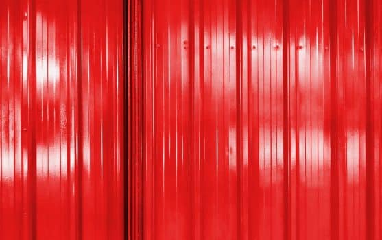 Full frame background of red corrugated door