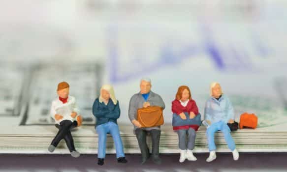 Travel and journey concept. Group of traveler businessman miniarure figure people sitting and waiting on passport with immigration stamped.