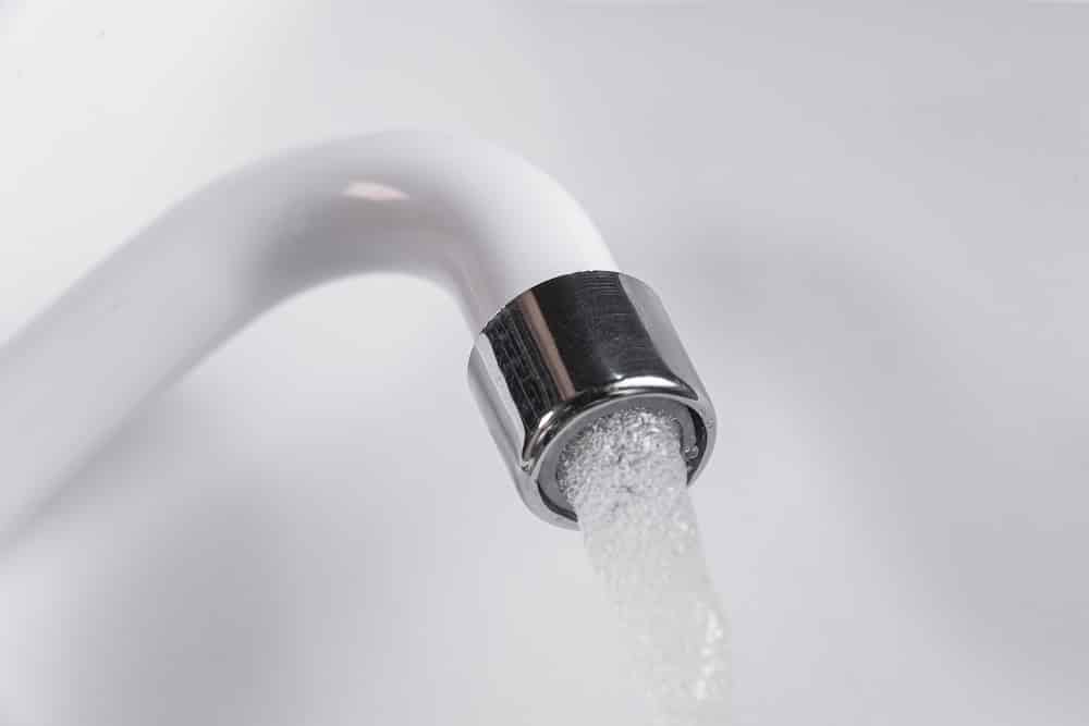 White kitchen sink faucet - close up