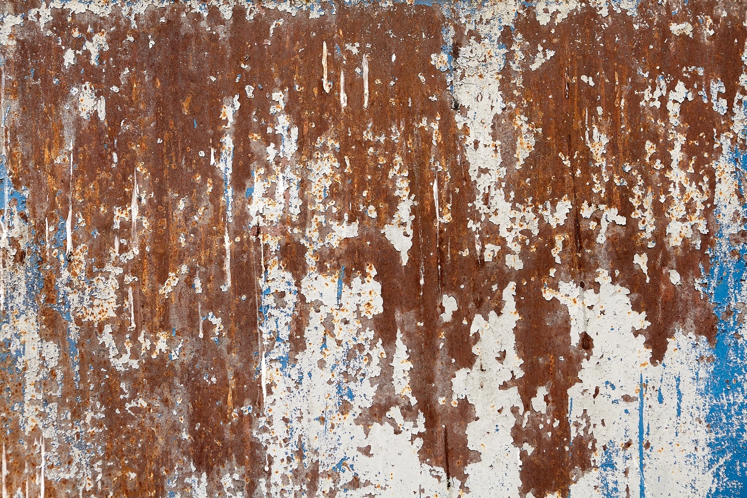 Surface of steel wall with peeling paint and corrosion, texture backdrop. Paint stripper for metal buying guide .