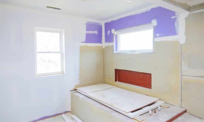 Master Bathroom with new under construction bathroom interior drywall ready for tile in new luxury home