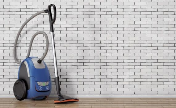 Home appliance concept. Modern vacuum cleaner in front of brick wall. 3d rendering.