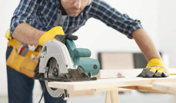 Carpenter working with circular saw