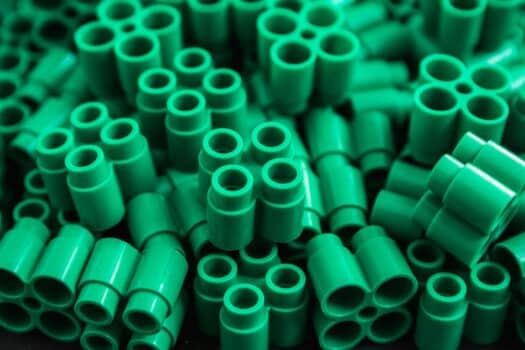 Plastic bricks of green color and details of toys. Green background. Close up! Best lego sets