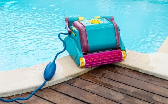 Robot cleaner on a swimming pool border. Maintenance pool concept