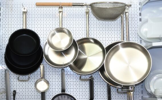 Several empty frying pans on a white background.