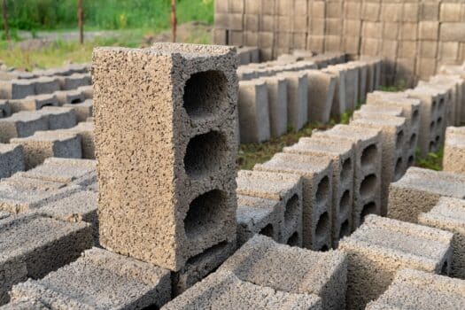 Stacks of gray concrete blocks on the ground, industry