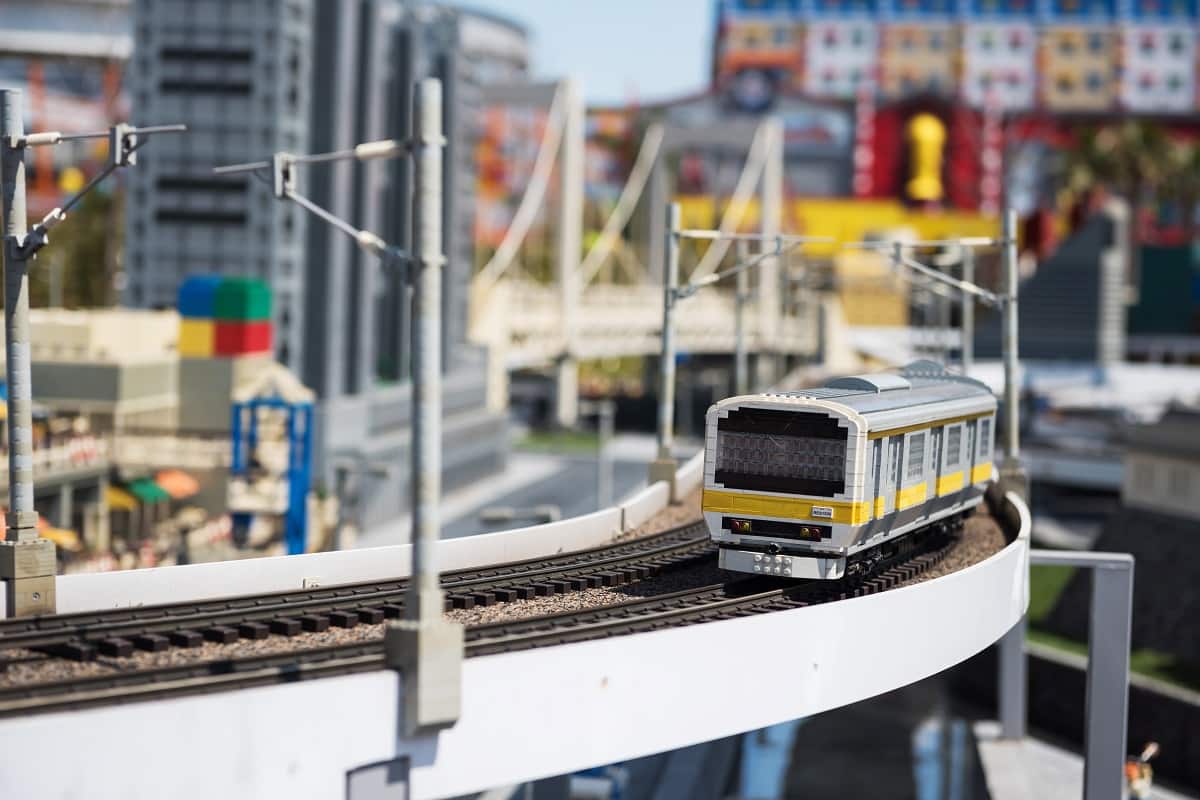 Nagoya, japan - april 08, 2019: local jr train lego model running on railway with city background of japan legoland. Famous theme park landmark espcially for children age around 1 to 7 years old.