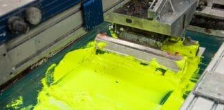 equipment and machines for painting cloth at a garment factory closeup. How To Do Screen Printing.