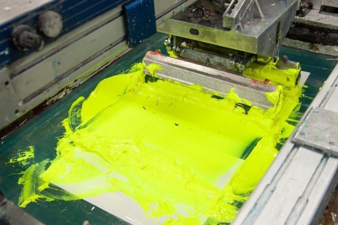 equipment and machines for painting cloth at a garment factory closeup. How To Do Screen Printing.