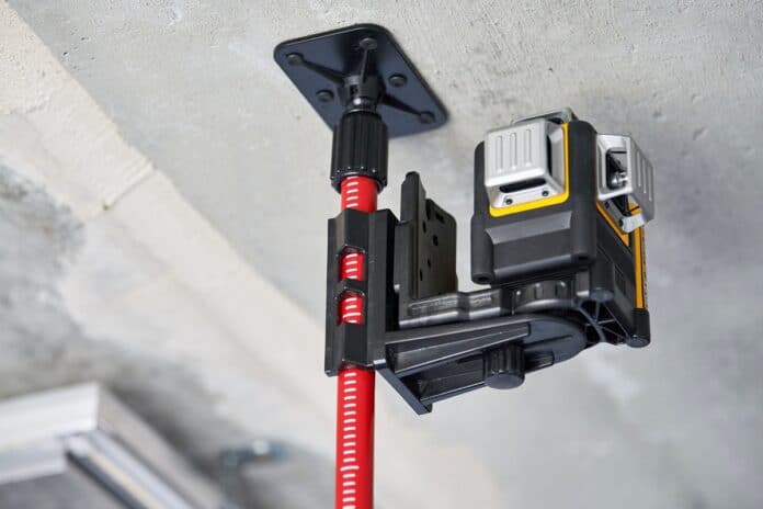 Laser level measuring tool at construction site, close up. Measuring level in unfinished apartment. Professional equipment for measurement. Construction quality. Measuring Tools For Engineering.