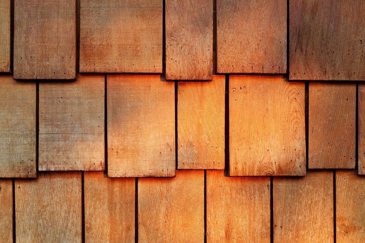 Abstract wooden texture of red cedar shingles, shake wood siding row roof panel. Cedar wood shingle siding.