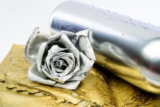 Floral wine. Metal flower in steel silver bottle. Forging and sculpture. Silver metal. Romantic date. Birthday gift. Silver fashion. Alcohol drink. Luxury wine. Metallic silver color. Winery concept. How to paint chrome.