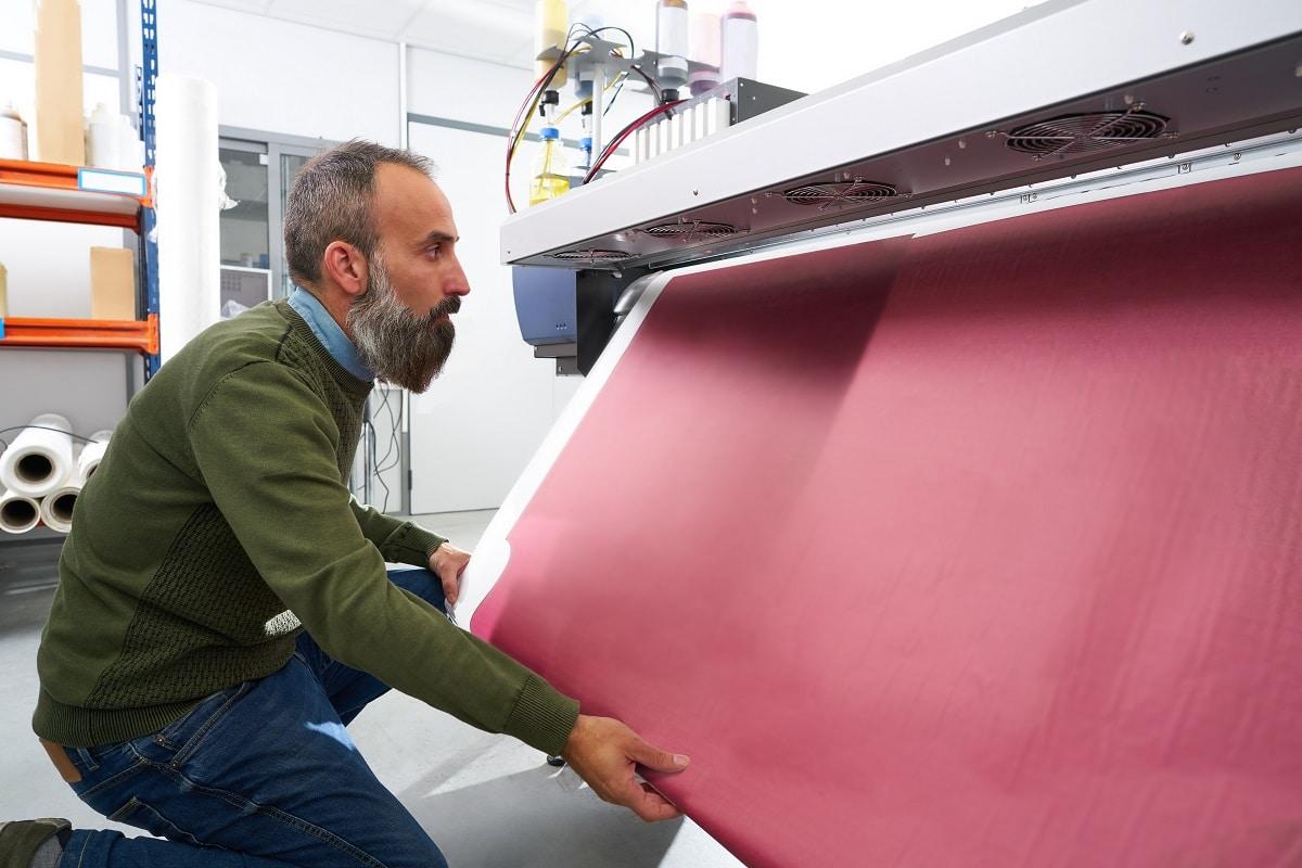 Espertise man in transfer printing industry plotter printer hipster beard. What are plotters used for.