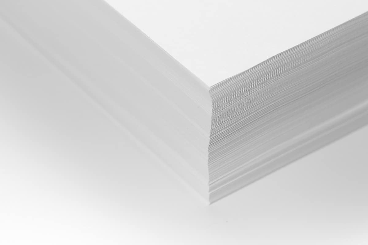 Minimalism. Top view of a stack of office paper for the printer with blank space for information. What paper size is 11x17 final remarks.