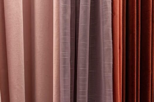 Set of multi-colored dense fabrics of uniform texture, choice of materials in different colors. What are blackout curtains.
