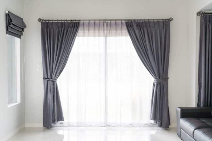Curtain interior decoration in living room with sunlight. Do Blackout Curtains Keep Heat Out.