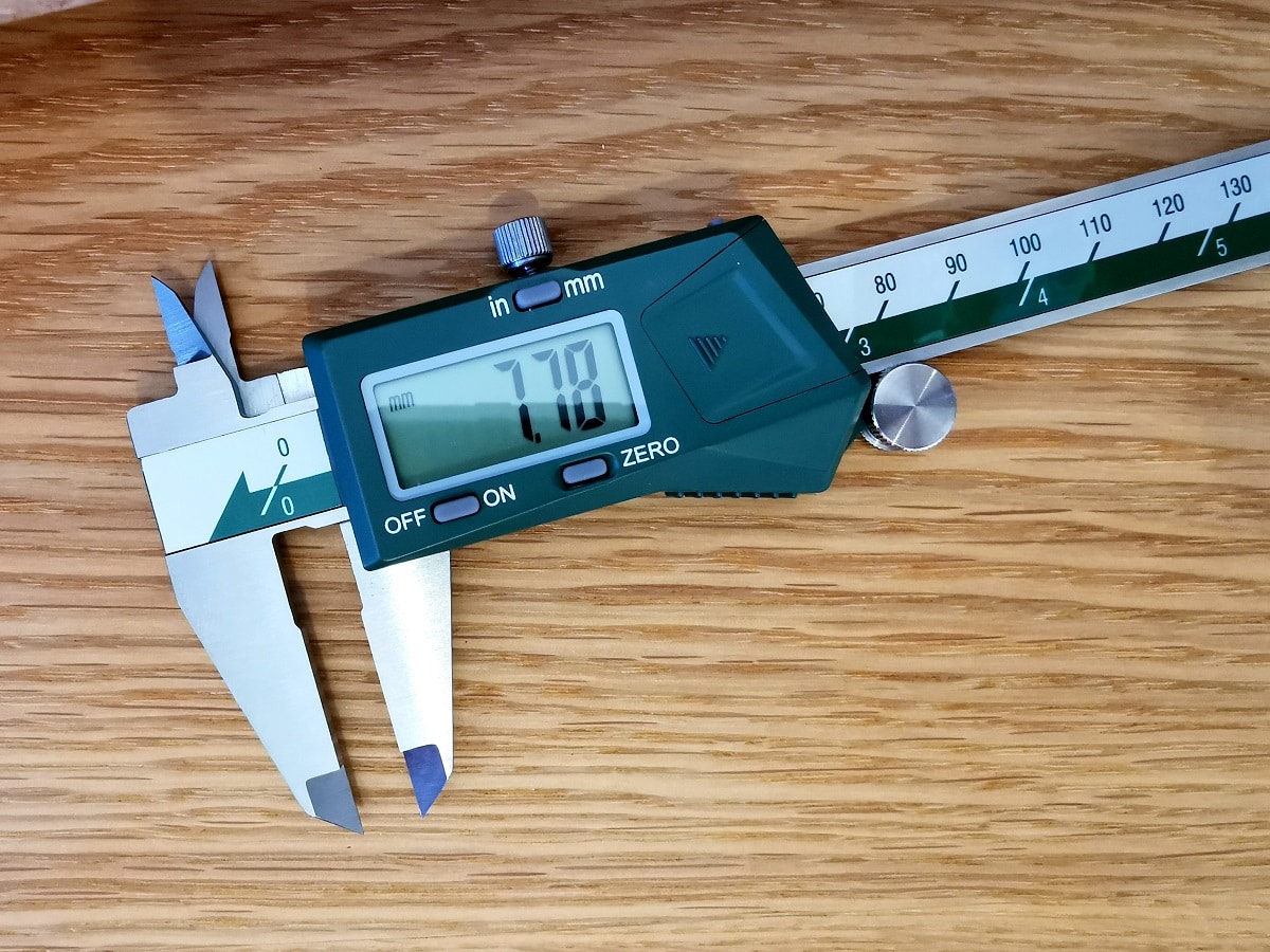 Digital caliper on oak hardware piece