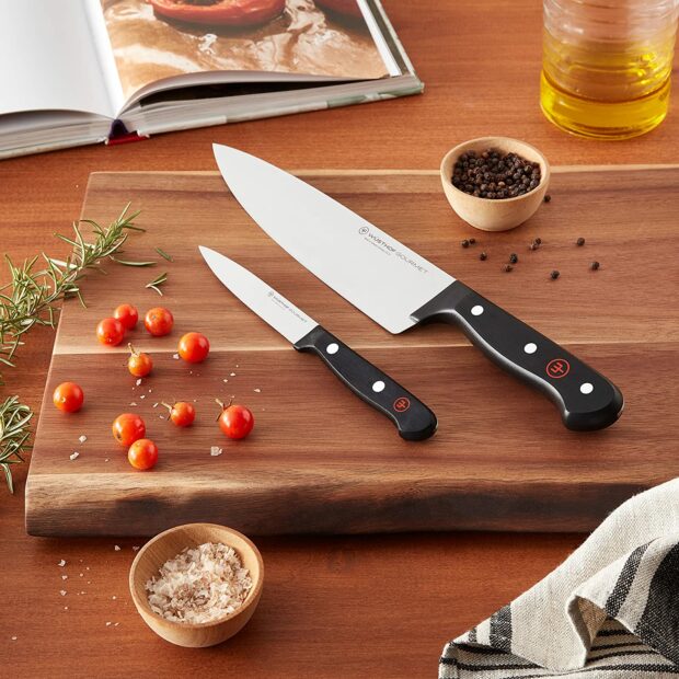Two wusthof knife with berries and cutting board