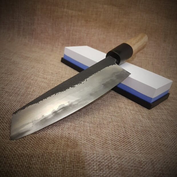 Imarku knife on a stone sharpener