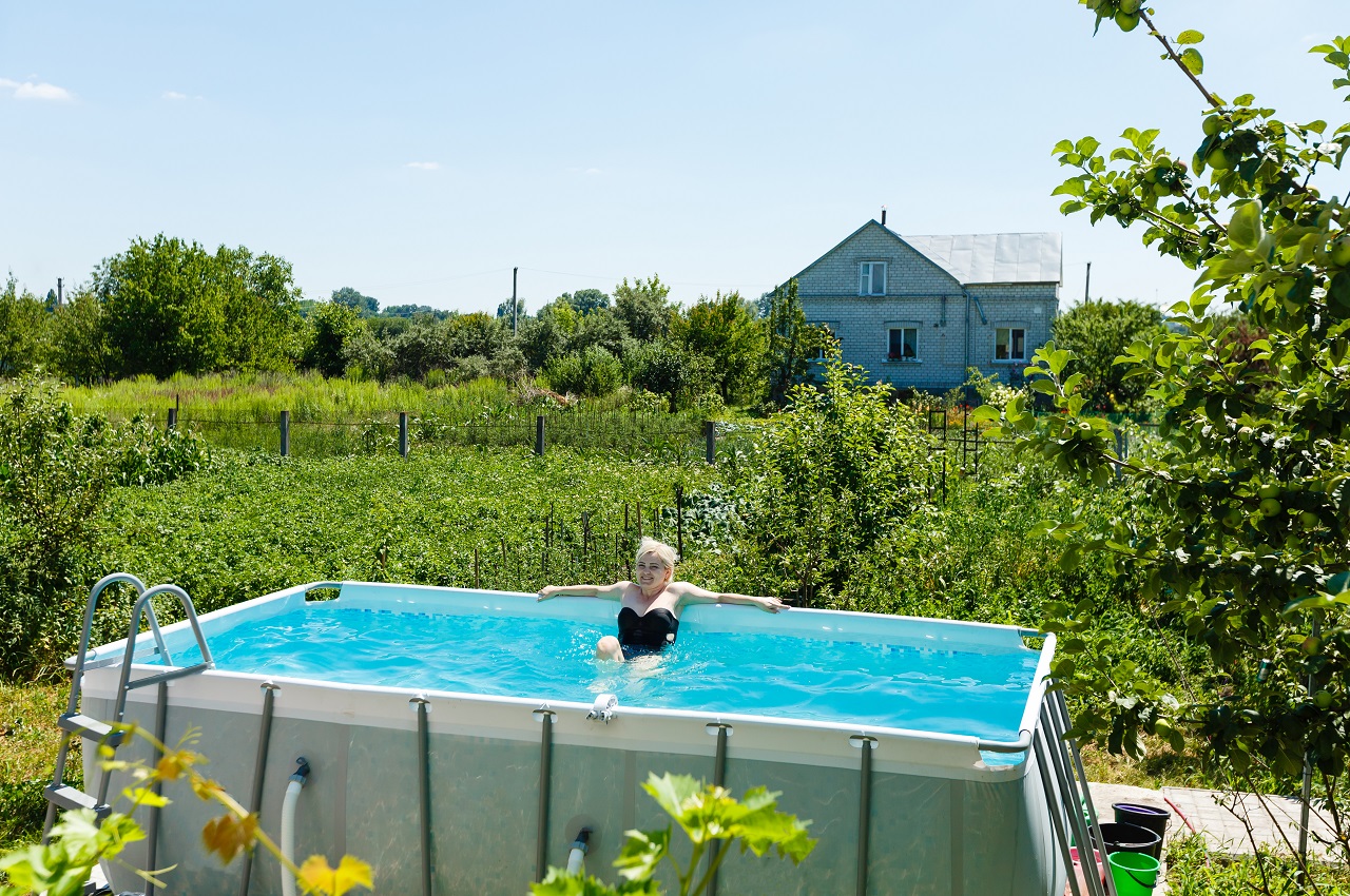 Private swimming pool at summertime. Above-ground swimming pool.