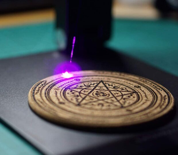 A laser engraving a round object