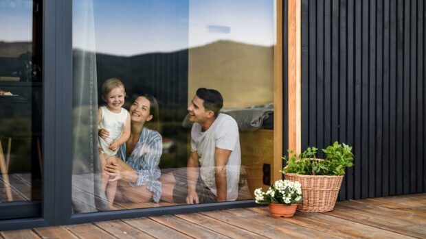 Happy family inside a fiberglass window