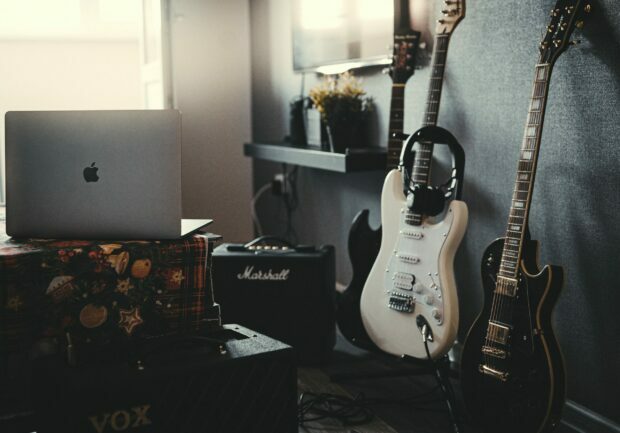 Three guitars with laptop and amplifier
